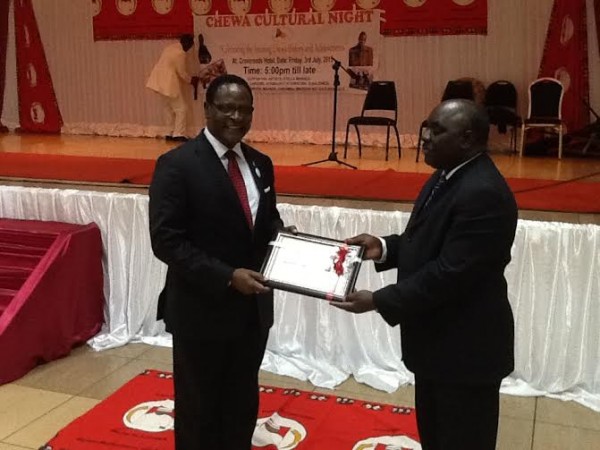 Chakwela receiving the award from Vuwa.-Photo by Alfred Chauwa