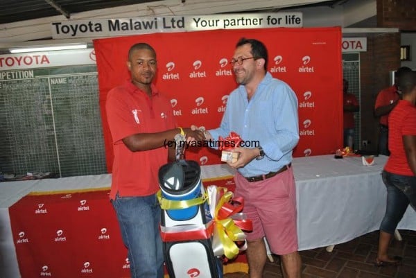 Champion Adam Sailes gets his prizes from Airtel MD