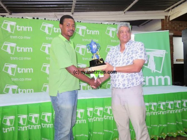Champion Sailesi (left) gets his trophy from TNM
