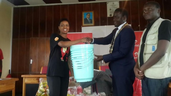 Chavula presenting the relief items to Mzuzu Mayor