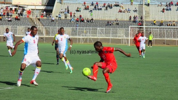 Chawanangwa doing what he knows best as a DRC defender looks on....Photo Jeromy Kadewere.