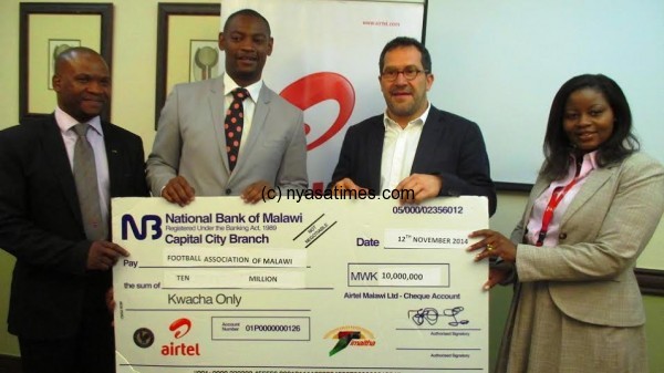 Cheque presentation: Airtel boss gives the cheque to FAM president Nyamilandu.- ....Photo Jeromy Kadewere