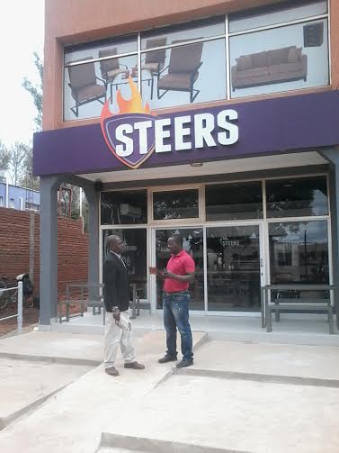 Chikhungwa (right) interacts with a customer outside the new premises