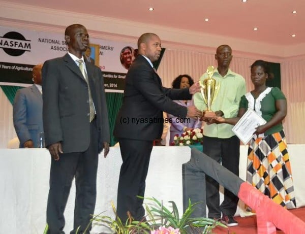 Chilima, presents an award to best farmes association from Karonga .-Pic. by Abel Ikilon