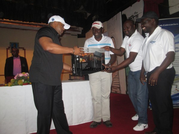 Chilima presents prize to Zacharia Hara who won with David  Nyirenda of Macra team