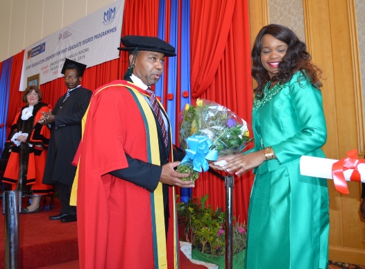 Chilima receives flowers from Madam Chilima after the award of the Doctoral Degree at BICC - Pic by Stanley Makuti