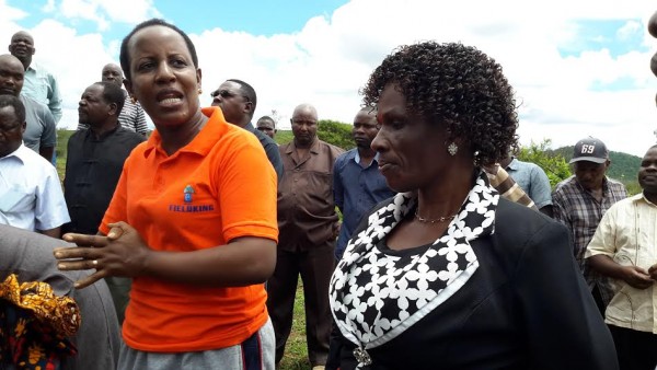 Senyamule in red top gear addresses officials, as Chirwa listens, after tree planting exercise