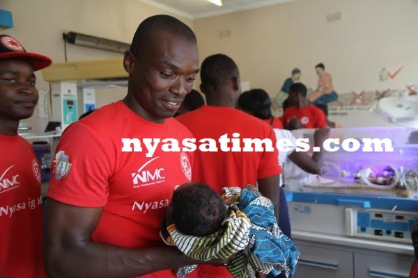 Chiukepo Msowoya admiring a baby...Photo Jeromy Kadewere