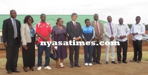 Chiumia, Shuichiro pose with Moc officials in front of the new building