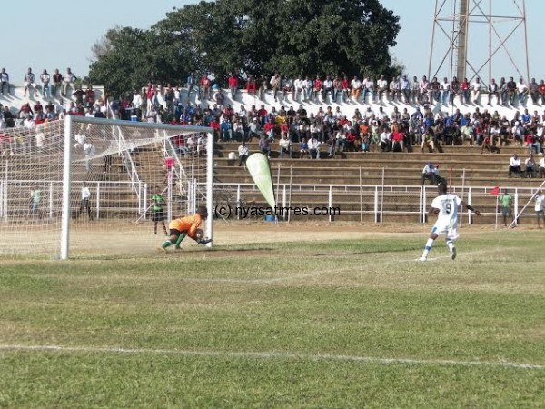 Civo goalie Duncan Mkandawire spills a free kick by Kaziputa.