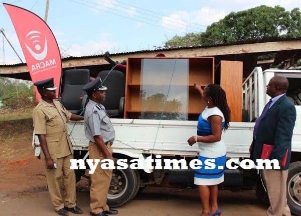 Clara Mulonya showing the Police incharge some of the furniture