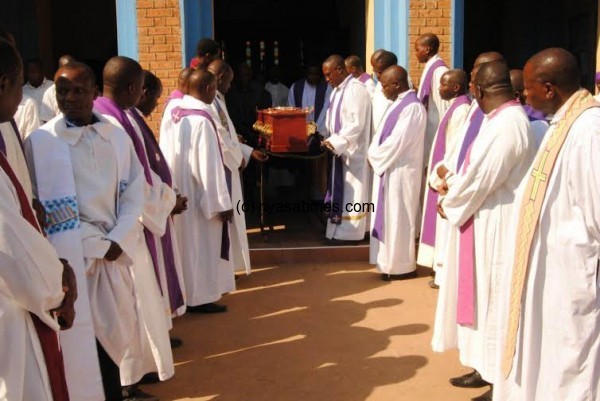 Clerics carrying the casket of late Fr Kunkeyani.-Photo Jeromy Kacdewere