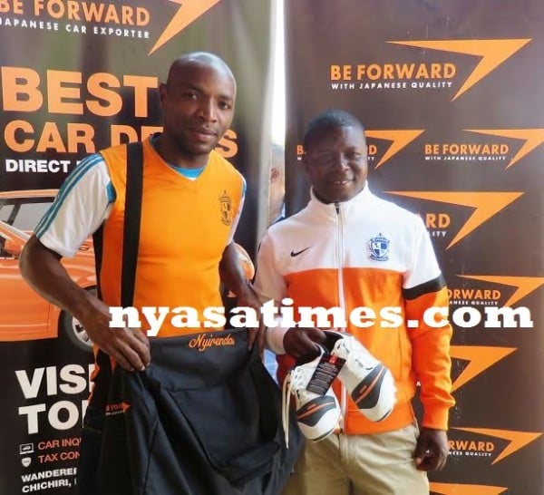 Coach Elia Kananji with his player showing the boots- Photo Jeromy Kadewere