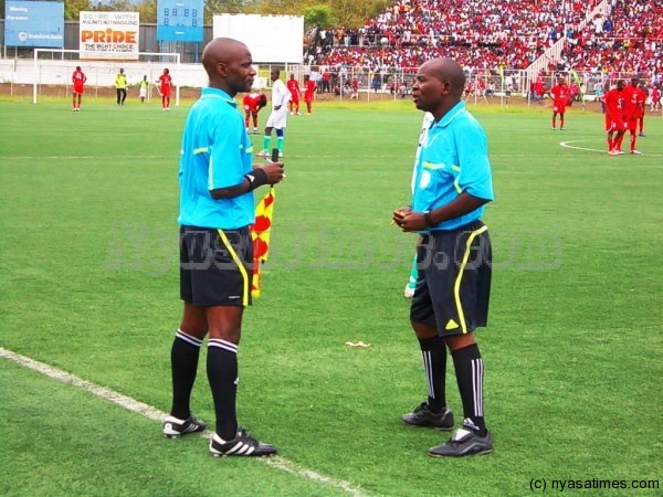 Referee consulting his assistant