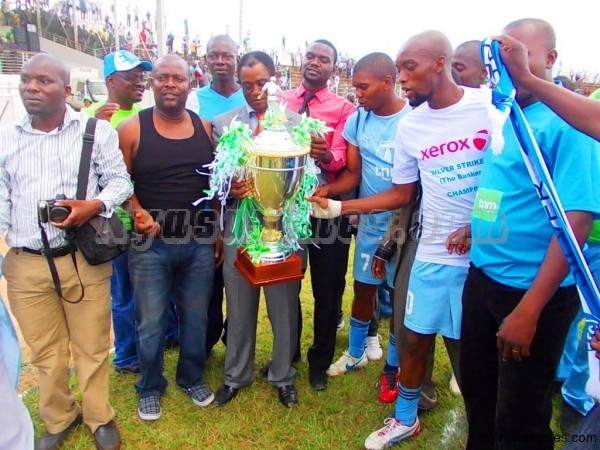 We are champions! Silver players, officials and supporters pose wth the TNM Super League trophy.-Photo by Jeromy Kadewere/Nyasa Times