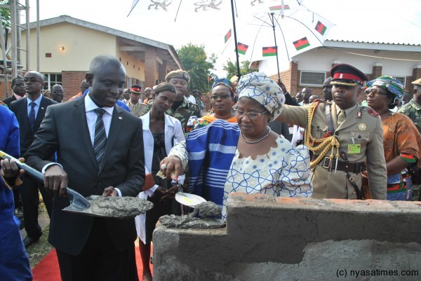 President Banda laying a foundation stone is Charles Asiedu from Ecobank.
