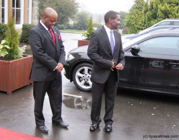 Deputy Malawi High Commissioner to the UK John Tembo Jnr and Minister Mganda Chiume await the President to alight from her limousine
