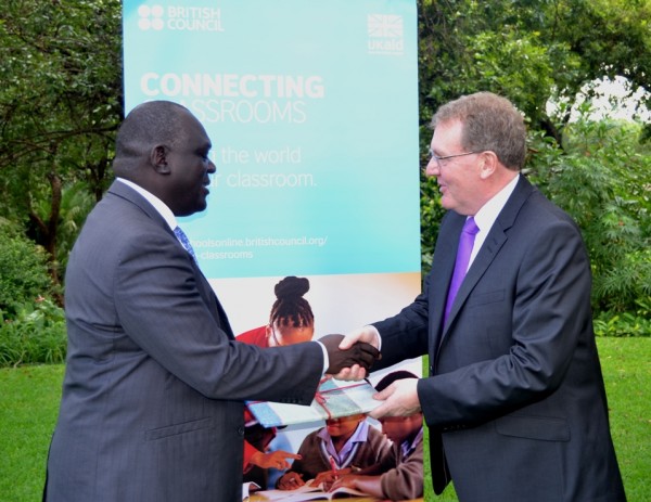 Deputy Minister of Education Science and Technology, Vincent Ghambi receives a gift from UK Minister and Secretary of State for Scotland, David Mundell-(c) Abel Ikiloni, Mana