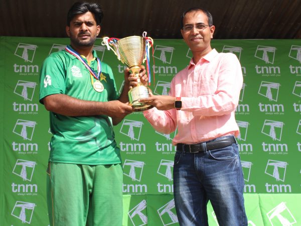 Deshmukh presenting a trophy to Mahmood