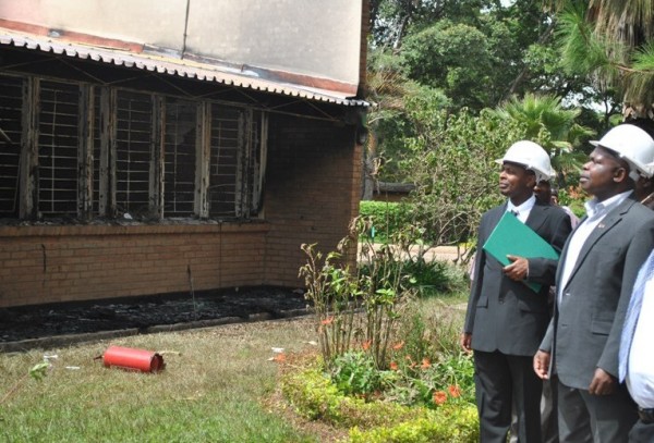 Dr Fabiano (middle), franked by Mzuni officials, takes  look at the burnt library building at Mzuzu University in the city. pic by  Trouble Ziba, Mana