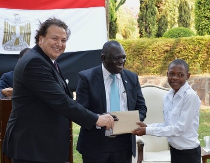 Egyptian Ambassodor to Malawi Maher El-Adawy  and the Deputy Minister of Education Vincent Ghambi C presents a Scholarship to a 15 year old  Jameel Ismail of Bedir International School - Pic by Stanley Makuti