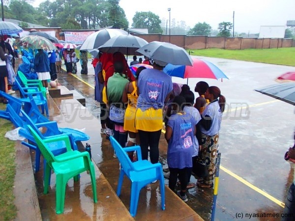Escom Sisters players in umbrellas after the game was stopped due to heavy rains...Photo Jeromy Kadewere