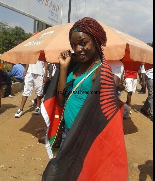 Carrying the Malawi flag in support of Flames