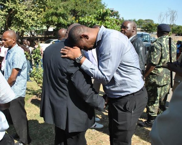 Fam President Walter Nyamilandu consoling Godfrey's father...Photo Jeromy Kadewere