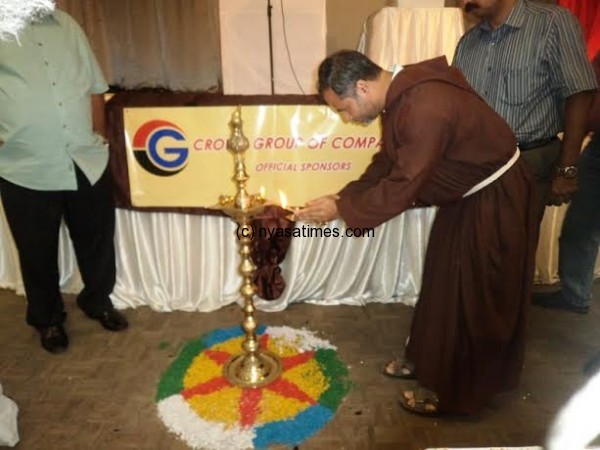 Father Gracian Lighting a Candle