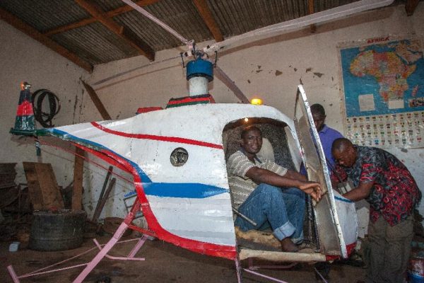 Malawian Felix Kambwiri sits in the cockpit of the helicopter he built out of scrap metal and fibreglass in his garage on February 19, 2016. Amos Gumulira/AFP