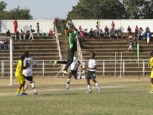 Fisd goalie Brighton Munthali rises high to get an aerial ball, Pic Alex Mwazalumo