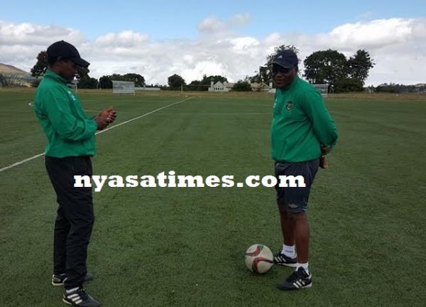 Flames Coach Ernest Mtawali talks tactics with his deputy Nswazwirimo Ramadhan