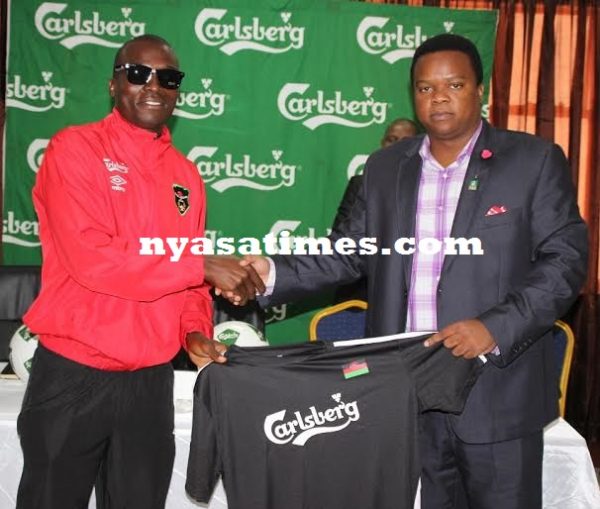 Flames captain Chiukepo Msowoya receiving a branded Carlsberg Malawi jersey...Photo Jeromy Kadewere