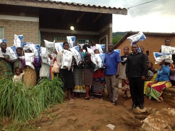 Flood victims display their relief items received from CCAP.-Photo by Anthony Kasunda