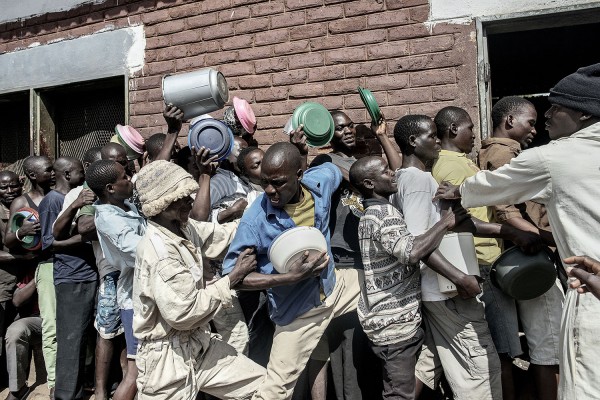 MALAWI. Blantyre. May 27th, 2015.  Food distribution in Chichiri Prison. Prisoners are fed just once a day, due to the small budget that Malawian Government allocates to the penal system. The quality of the food is miserable - six days of Nsima (boiled corn flour with no salt or other ingredients) and boiled beans once a week. As a consequence cases of malnutrition are common.Luca Sola/MSF