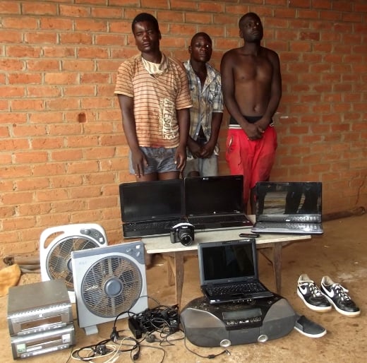 From left to right - Maganiza Banda and francisco and in front the recovered items - Pic. By Kondwani Magombo