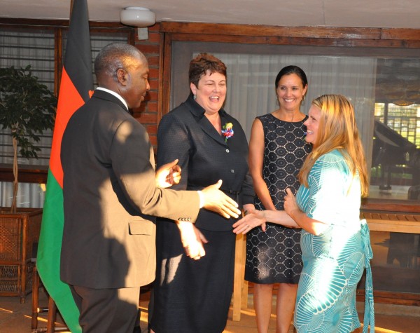 GHS Volunteer being congratulated by PS Msosa as Amb. Palmer and Peace Corps Malawi Director Carol Spahn looks on 
