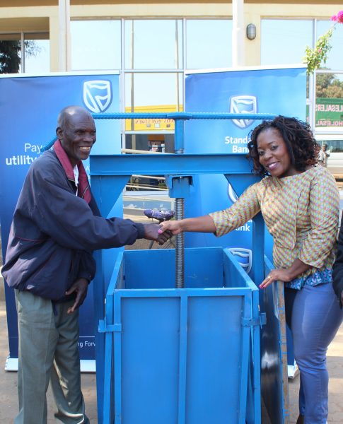 Good Luck! One of fortnight winners Robertson Chinguwe receiving  bailing jack from Bank's Head of Marketing Thoko Unyolo.