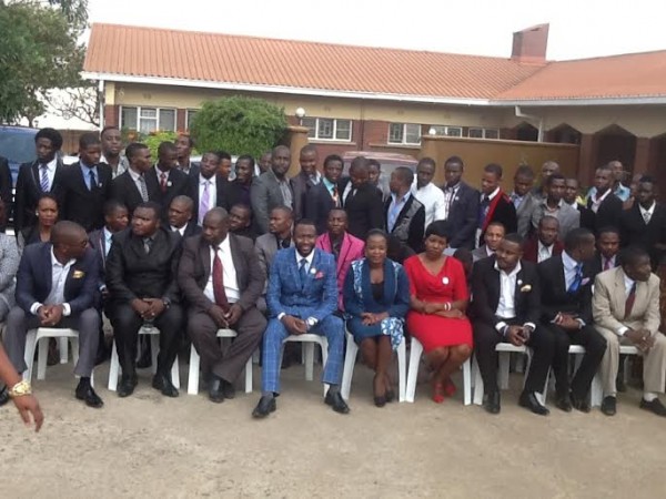 Group photo with Hara in blue suit during the training