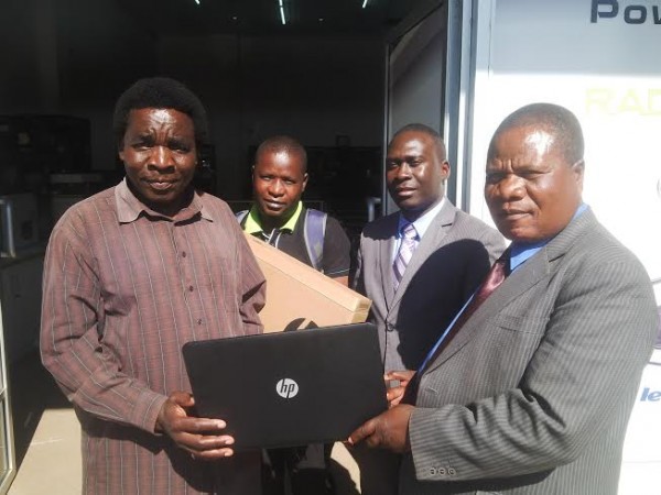 Harawa and Kapichi  of CRFA admiring the laptop with Tiya Somba behind looking and Antonio Manda CRFA fixtures secretary - Photo by Mphatso Nkhoma, Nyasa times