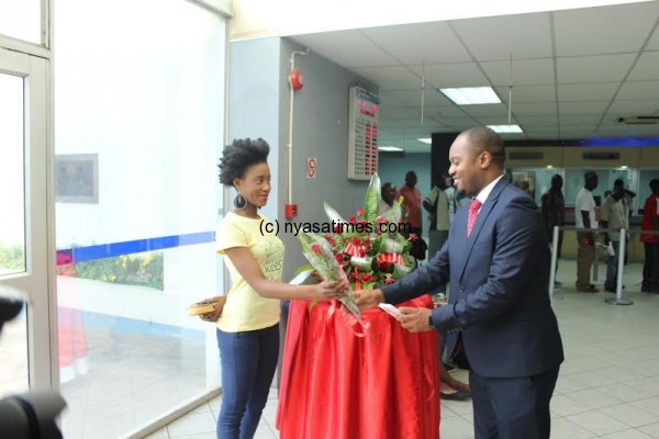 Head of Business Banking Ronald Tembo giving a rose flower to one of the customers at Blantyre branch