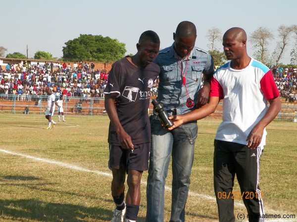 Here is some water, Mhone escorted by colleagues after seeing red, Pic Leonard Sharra, Nyasa Times