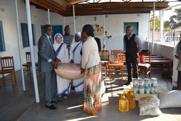  Kasaila (R) and Hon Lunguzi (L) helping each other to hand over a bag of maize to the sisters