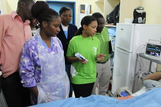 Hospital officials showing Mr Nyirenda on how the Oxygen concentrator works