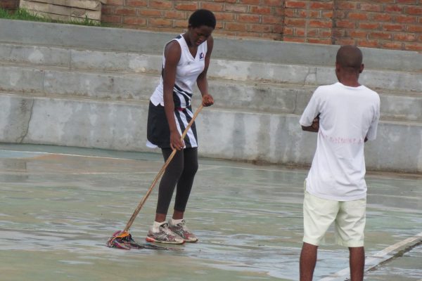 Mopping the netball court