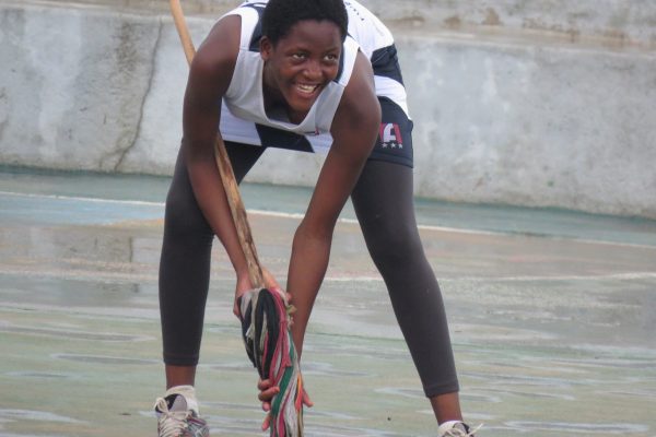 Netball players mopping the court before playing