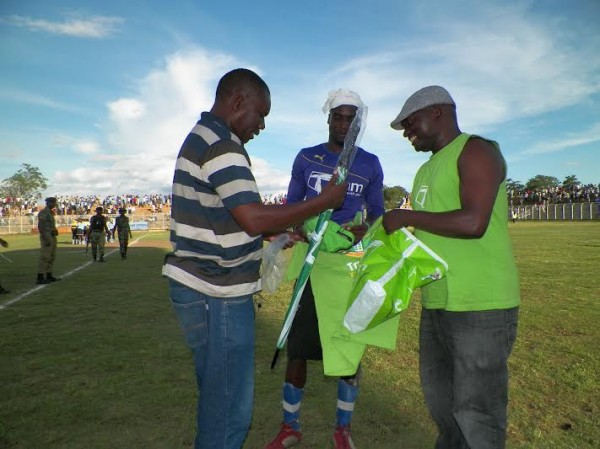 Its all yours, Evirom goalie Blessings Kamiza gets his man-of-match prize from Sulom, TNM officials, Pic Leonard Sharra