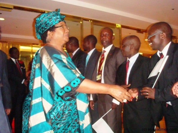 JB greets an official from the Ministry of Economic Planning and Development Charles Mtonga