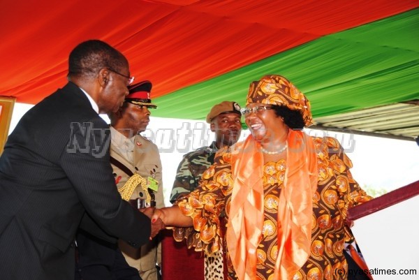 JB in jovial mood shakes hands with Professor Peter Mwanza