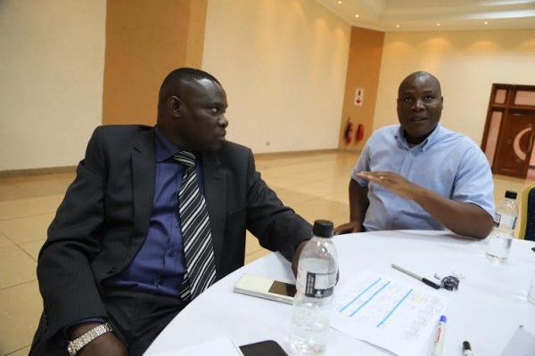 Kafweku (L) shares notes with one of the participants